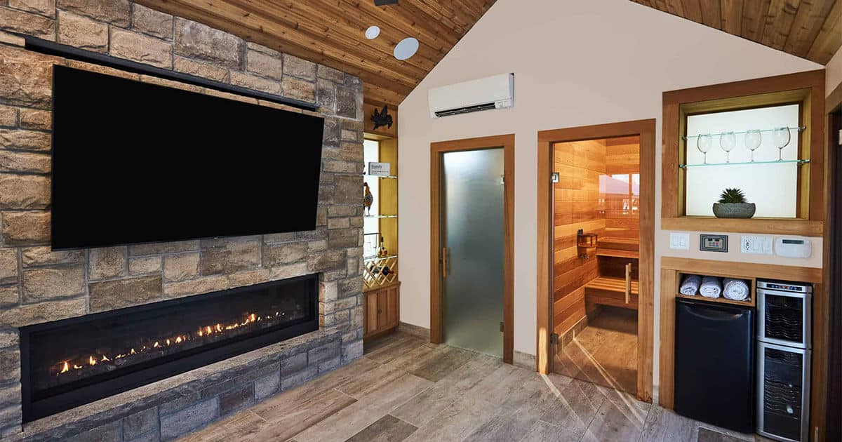 View of finished basement with TV, fireplace and sauna entrance
